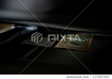 Using a copy machine to print forgery currency.  117001587