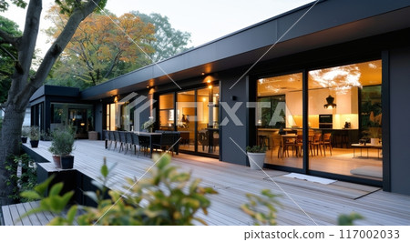 Modern Home Exterior With Glass Wall and Wooden Deck Surrounded by Nature 117002033