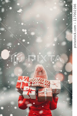 Woman Carrying Gift Boxes in Snowy Urban Setting During Winter Holiday Season 117002166