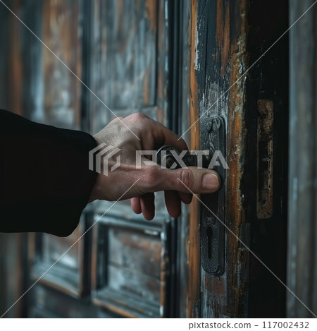 close-up of a hand opening an old door close-up of a hand opening an old door 117002432