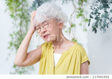 Senior woman suffering from heat stroke in summer 117002892