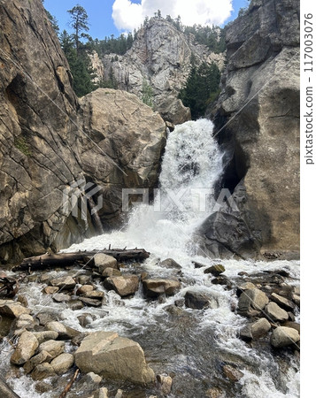 A waterfall flowing between the rocks 117003076