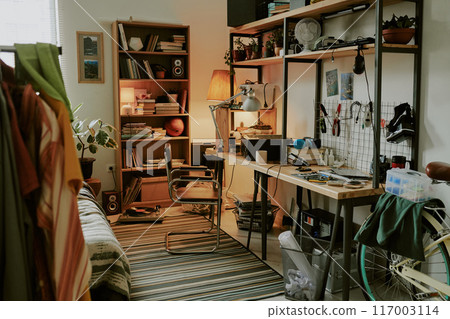 Modern work desk with instruments and wreckages on top in dorm room of young technician 117003114