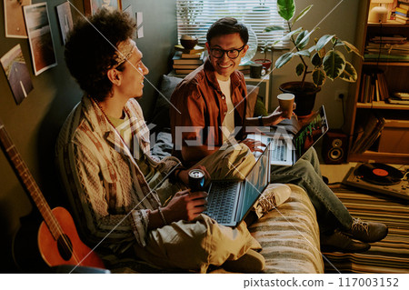 Beginner startupers drinking different beverages and chatting while having break after several hours of coding Beginner startupers drinking different beverages and chatting while having break after several hours of coding 117003152