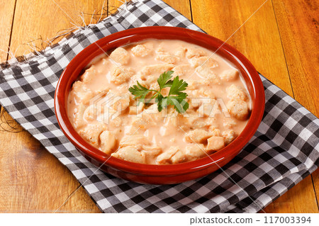 homemade chicken stroganoff in ceramic bowl on rustic wooden table 117003394