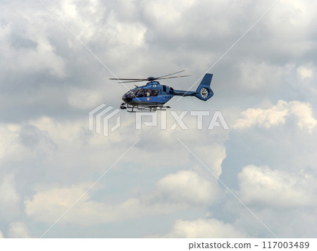 A helicopter of the Osaka Prefectural Police Aviation Unit flying in the midsummer sky A helicopter of the Osaka Prefectural Police Aviation Unit flying in the midsummer sky 117003489