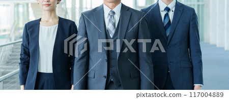 Business people walking down an office corridor Business people walking down an office corridor 117004889