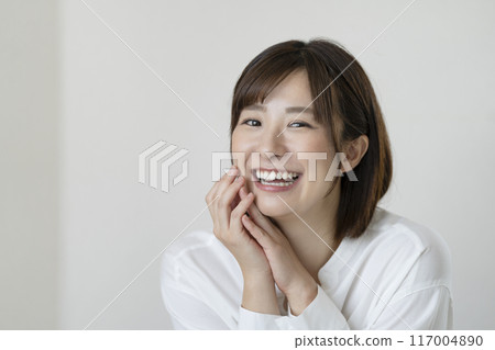 A woman in her early 30s smiling at the camera A woman in her early 30s smiling at the camera 117004890