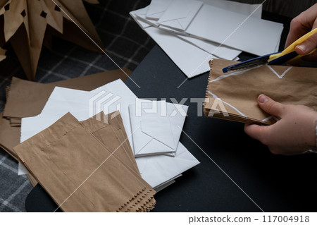 Master class of cutting making craft paper snowflakes for conscientious Christmas decor. Sustainable celebration minimal responsible DIY holiday project. Step by step 117004918