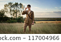 A young adventurer standing on a mysterious prairie 117004966