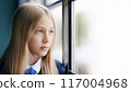High school girl looking out the window 117004968