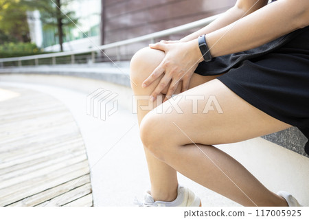 Middle aged woman holding knee,pain in kneecap or muscles around knee joint,patella friction against the thigh bone,disease of Runner's knee or Patellofemoral pain syndrome,ligament injury,health care 117005925