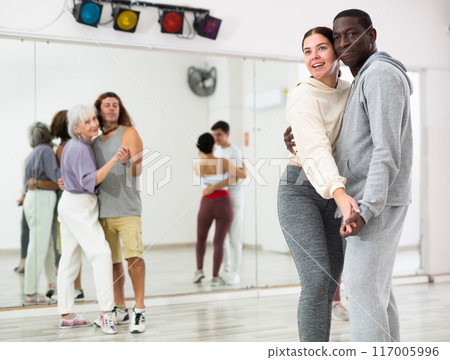 African man and caucasian lady rehearsing latin paired dance moves African man and caucasian lady rehearsing latin paired dance moves 117005996