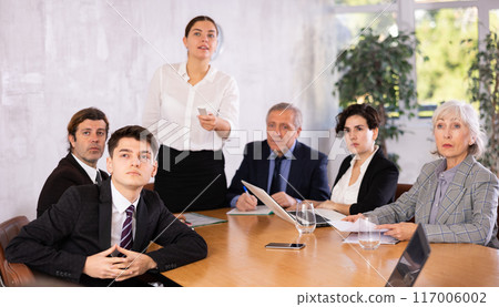 Young guy watching presentation during business training in office Young guy watching presentation during business training in office 117006002