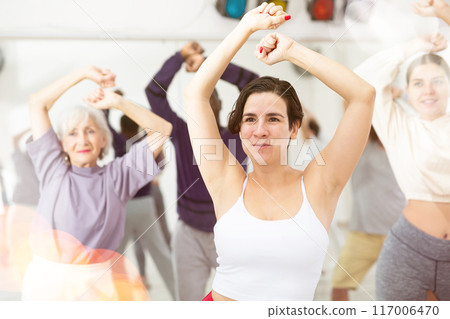 Young Hispanic woman practicing vigorous dance movements Young Hispanic woman practicing vigorous dance movements 117006470