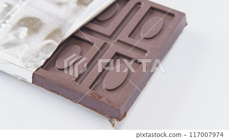 Chocolate bar wrapped in silver paper Chocolate bar wrapped in silver paper 117007974
