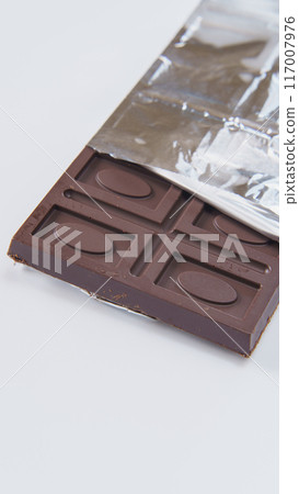 Chocolate bar wrapped in silver paper Chocolate bar wrapped in silver paper 117007976
