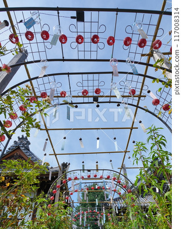A tunnel of small red lanterns and wind chimes A tunnel of small red lanterns and wind chimes 117008314