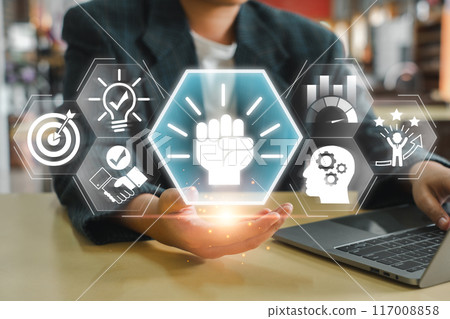 Businessman holding holographic icons symbolizing motivation, success, innovation, and growth, ideal for business and professional themes. 117008858