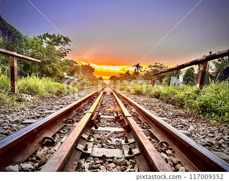 Perspective of Railroad tracks in the evening, in the countryside for the abstract background vintage retro concept. Perspective of Railroad tracks in the evening, in the countryside for the abstract background vintage retro concept. 117009352
