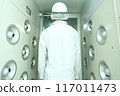 A worker taking an air shower 117011473