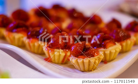 Beautiful multicolored decorated baked sweet tasty party cakes or catering cakes for party, bar dessert selection with cake, pie and pastries catering banquet, coffee break buffet at a conference 117011549
