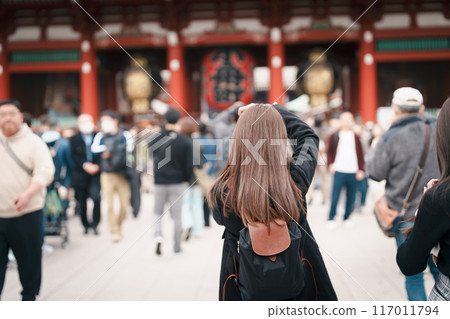 Tourist woman visit Sensoji Temple or Asakusa Kannon Temple is a Buddhist temple located in Asakusa, Tokyo Japan. Japanese sentence on red lantern means Thunder gate. 117011794