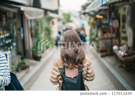 Woman tourist Visiting in Enoshima Island, Fujisawa, Kanagawa, Japan. happy Traveler sightseeing Enoshima Shrine. Landmark and popular for tourists attraction near Tokyo. Travel and Vacation concept 117011830
