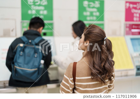 Woman tourist buy Ticket at automatic machine at Enoshima station, Enoshima Dentetsu train Line in Kamakura, Japanese railway connects Kamakura with Fujisawa Station in Fujisawa, Kanagawa Woman tourist buy Ticket at automatic machine at Enoshima station, Enoshima Dentetsu train Line in Kamakura, Japanese railway connects Kamakura with Fujisawa Station in Fujisawa, Kanagawa 117011906