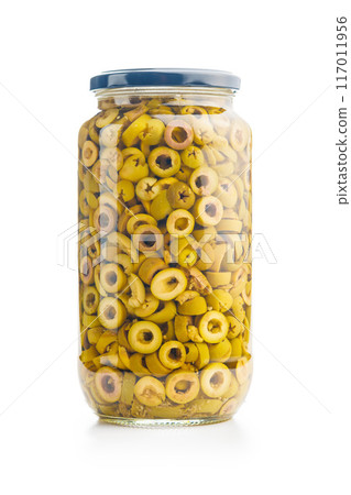 Sliced pickled green olives in brine in jar isolated on white background. 117011956