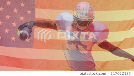 Image of african american american football player with ball and helmet and flag of usa 117012125