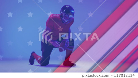 Image of caucasian american football player kneeling and flag of usa 117012134