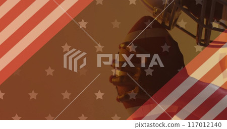 Image of caucasian american football player with ball and flag of usa Image of caucasian american football player with ball and flag of usa 117012140