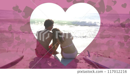 Image of heart cut out over diverse couple in love on beach in summer 117012216