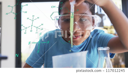 Conducting science experiment, child with safety goggles over chemical formulas image Conducting science experiment, child with safety goggles over chemical formulas image 117012245