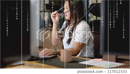 Image of binary data processing over tired biracial businesswoman using computer at office desk Image of binary data processing over tired biracial businesswoman using computer at office desk 117012333