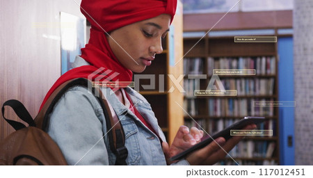 Image of ai text and data over biracial female student in hijab with tablet Image of ai text and data over biracial female student in hijab with tablet 117012451