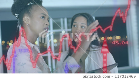 Image of financial data processing over diverse businesswomen in office Image of financial data processing over diverse businesswomen in office 117012469