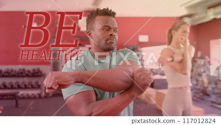 Image of be healthy text over diverse man and woman exercising in gym Image of be healthy text over diverse man and woman exercising in gym 117012824