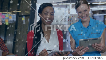 Image of binary coding data processing over diverse business people in office Image of binary coding data processing over diverse business people in office 117012872