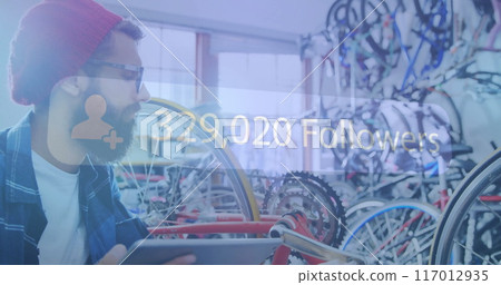 Man holding tablet in bicycle shop with 329,020 Followers image over 117012935
