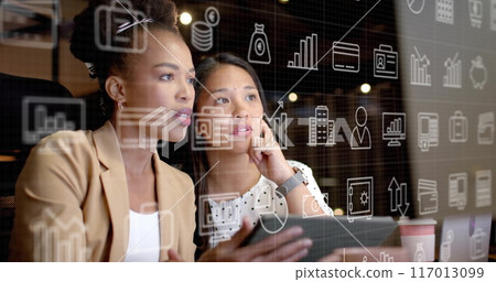 Image of currency and data processing over diverse businesswomen in office Image of currency and data processing over diverse businesswomen in office 117013099