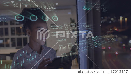 Image of financial data processing over african american businesswoman in office Image of financial data processing over african american businesswoman in office 117013137