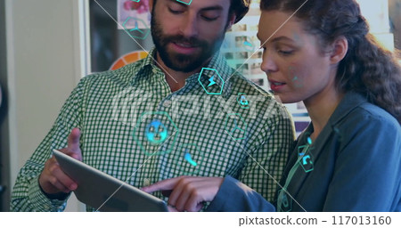 Image of ecology icons over diverse colleagues using tablet in office 117013160
