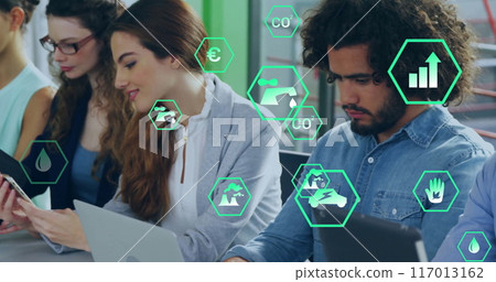 Image of ecology icons over diverse colleagues using technology in office Image of ecology icons over diverse colleagues using technology in office 117013162
