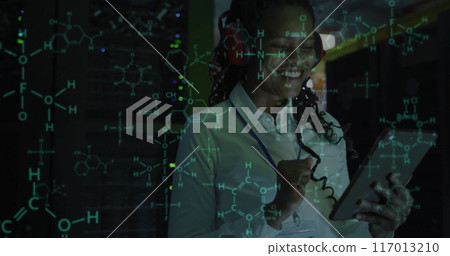 Image of scientific data processing over african american female it technician by servers Image of scientific data processing over african american female it technician by servers 117013210