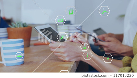 Image of ecology icons over diverse colleagues using tablet in office 117013220