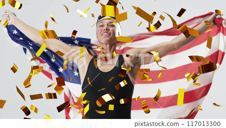Image of confetti over caucasian female swimmer holding flag of usa 117013300