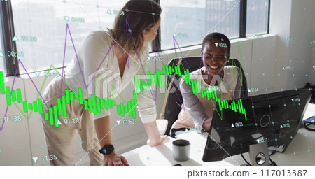 Image of graph processing data over diverse female colleagues talking at desk in casual office 117013387