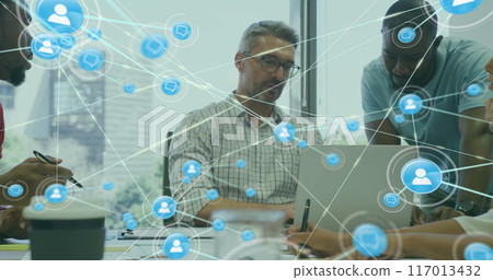 Image of network of connections with icons over diverse colleagues using laptop in office 117013432